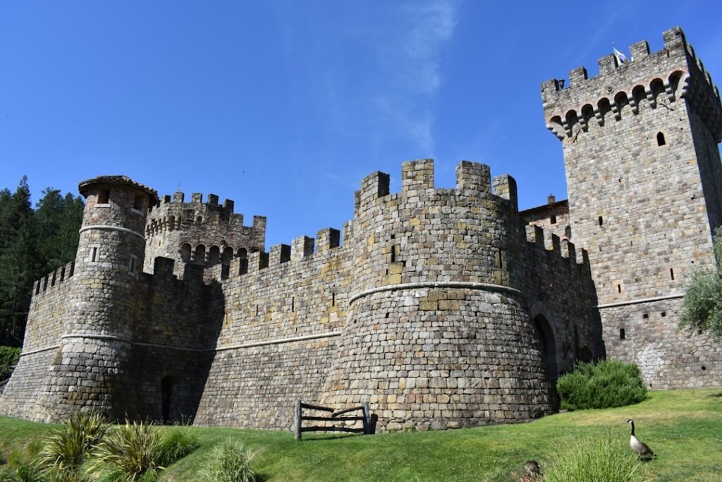 Stone castle with towers and battlements under blue sky