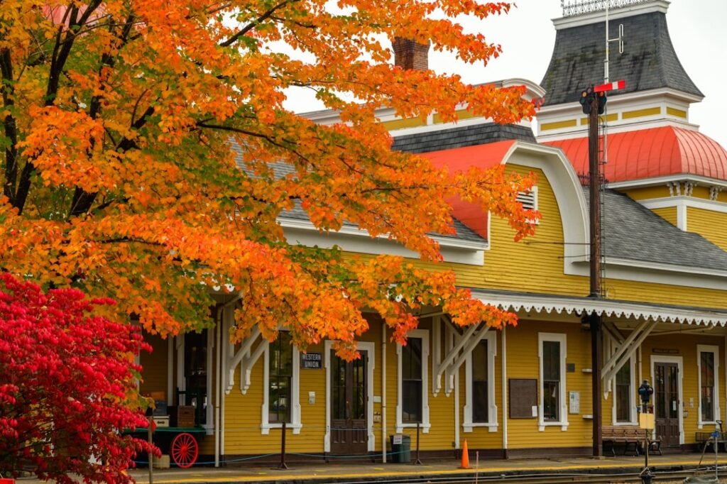 a yellow building with a red roof and a clock tower