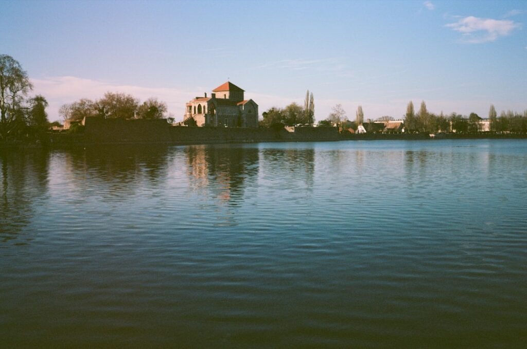 Castle-like building reflecting in a calm lake
