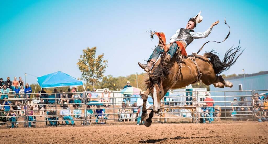 A man riding on the back of a brown horse