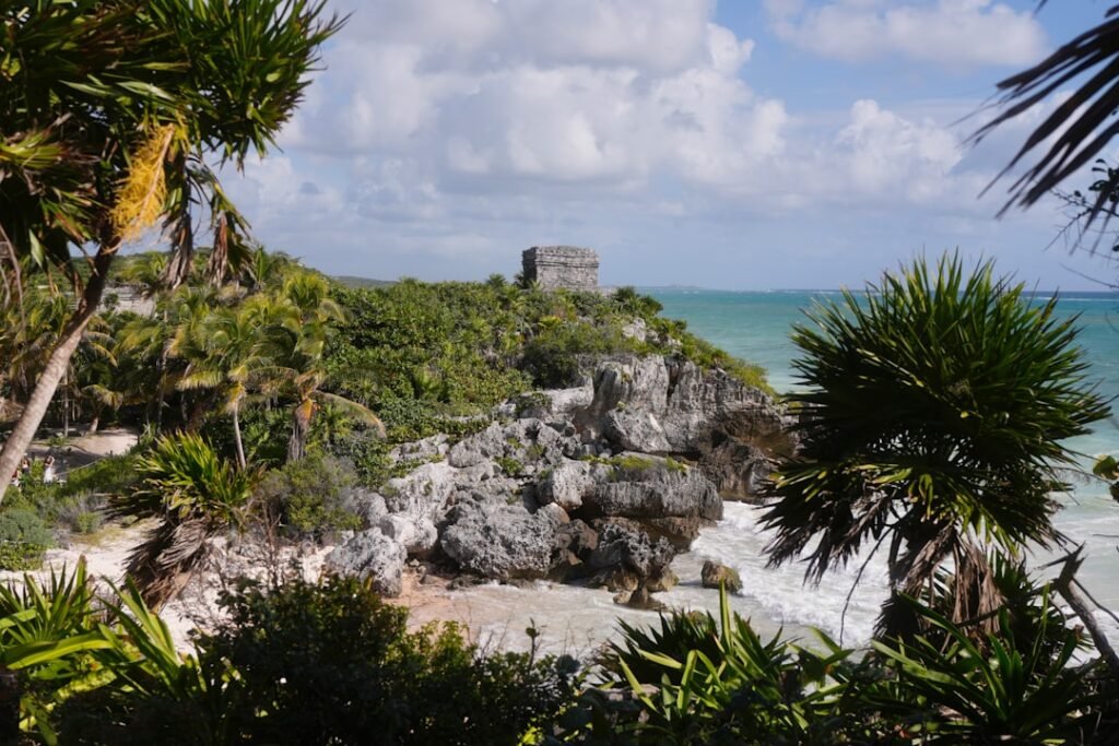 Ancient ruins on a cliff overlooking the ocean.