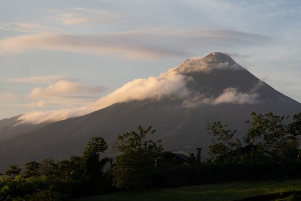 Volcano shrouded in clouds at sunrise